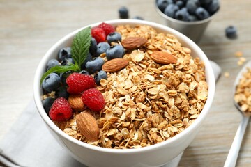 Delicious granola with berries on wooden background