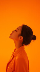 Korean beautiful girl taking photo with orange background and orange light