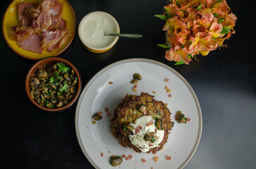 Rustic potato pancakes - stack of pancakes with bacon and sauteed mushrooms