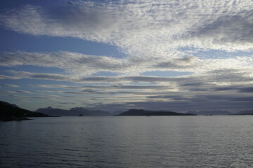 White nights in the fjords of Norway. Horizon and ferry crossing. Sky and clouds.	