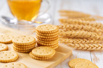 wheat round crackers and tea on a light kitchen table, selective focus.