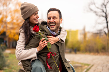 Happy Caucasian Man Carries Daughter in Park Adventure