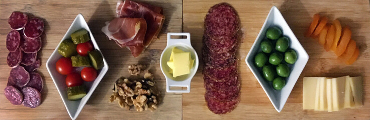 Cheese and charcuterie board with olive, walnuts and dried fruits