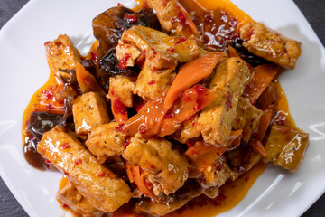 Kung Pao Tofu With Vegetables on a wooden background. Food concept. Chinese food.