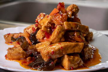 Kung Pao Tofu With Vegetables on a wooden background. Food concept. Chinese food.