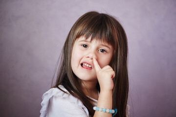 Little Girl Picking Her nose. Child is digging for treasure in her nose.
