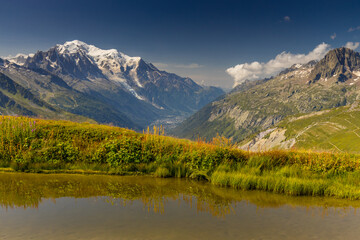 Fototapeta premium Mont Blanc, Monte Bianco mountain summit in the Alps. The highest mountain in Europe. Snow and glacier covered high altitude snow mountain in the Alps. The top of Montblanc Chamonix valley landscape