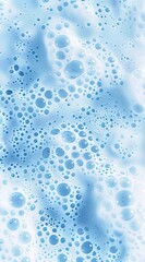 A close-up of blue foam with bubbles on it, against a white background.