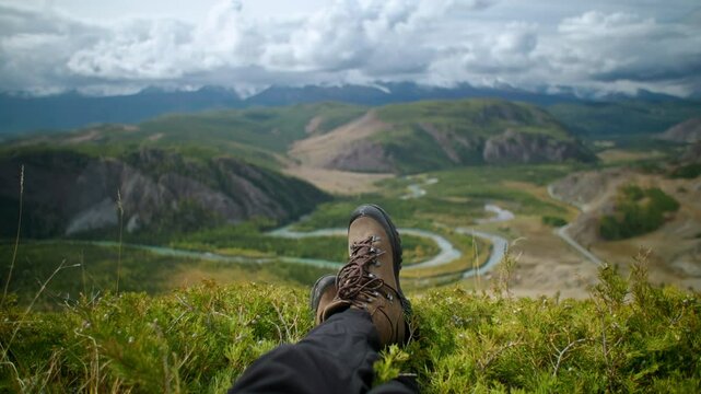 Close up boots travaler enjoying the serene and breathtaking mountain views while relaxing on peaceful hike in the great outdoors