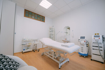 The interior of the massage and cometology salon, massage table. Nobody.