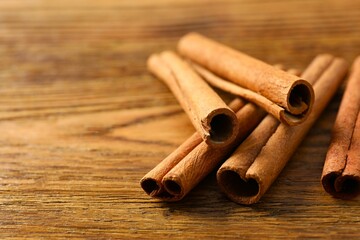 Cinnamon sticks on a wooden background
