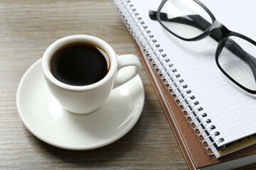 Workplace with notebook, glasses, cup of coffee, top view 