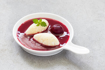 Cottage cheese quenelles with cherry sauce. Close-up	