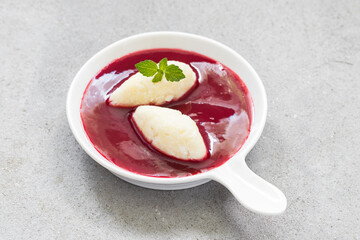 Cottage cheese quenelles with berry sauce. Close-up	