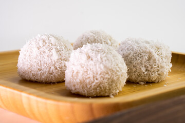 Japanese dessert mochi with red bean filling and coconut flakes. chopsticks.  food concept.