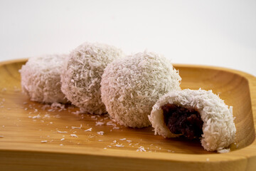 Japanese dessert mochi with red bean filling and coconut flakes. chopsticks.  food concept.
