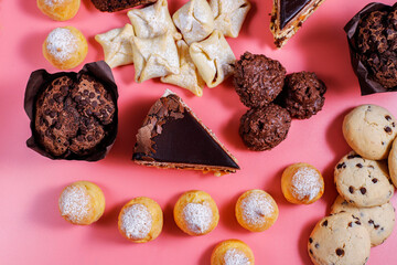 Table with various cookies, pound cake, cake slices, muffins and sweets.