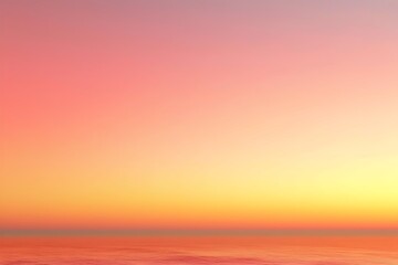 Fototapeta premium A breathtaking gradient of pastel colors fills the sky above a serene ocean, transitioning from soft pinks to warm oranges and yellows, creating a tranquil sunset atmosphere.