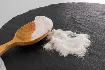 Close up of mono Monosodium glutamate (MSG)in spoon on white