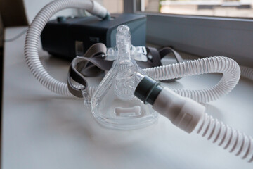 Advanced CPAP Machine with Attached Mask and Tubing on a Windowsill