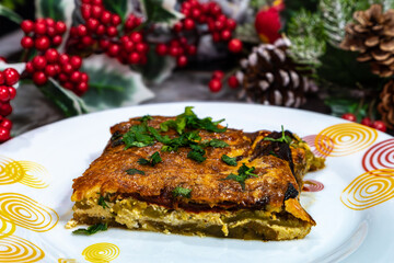 Festive Plate of Baked Casserole with Fresh Herbs and Holiday Décor
