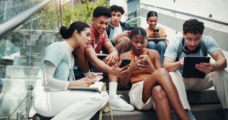Students, friends and tech on stairs at university, wow and share meme with diversity in low angle at campus. Group, people and happy on steps with phone, tablet or streaming comic video at college