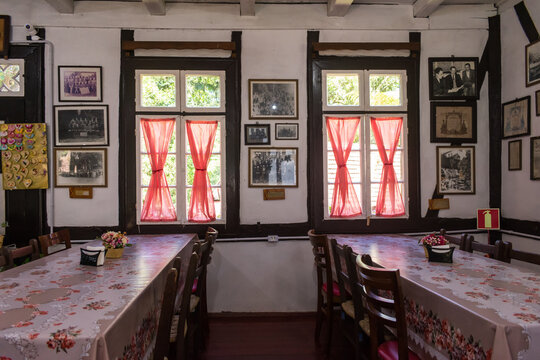 Nova Petropolis, Brazil - November 10th 2024: Tables and old pictures inside "Armazem e Casa das Cucas" bakery at Parque Aldeia do Imigrante