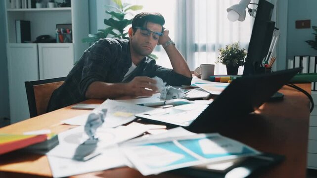 Skilled interior designer work on palettes and crumpled paper. Top view of skilled business man run out of idea while sleeping at meeting table. Project manager crumpled and throw paper. Symposium.