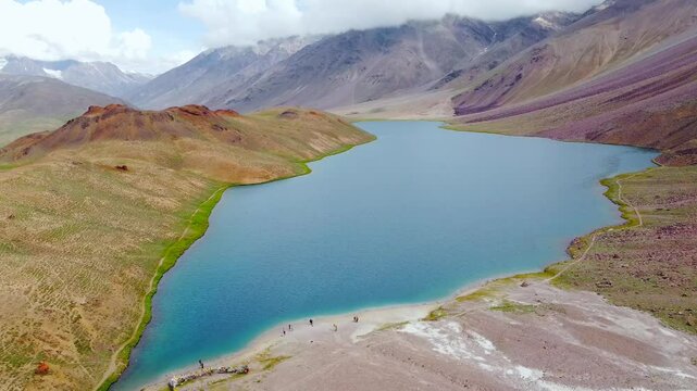 Aerial view of chandratal lake surrounded by snow-capped Himalayan mountains at chandratal in lahaul and spiti valley himachal pradesh, India.