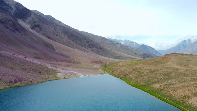 Aerial view of chandratal lake surrounded by snow-capped Himalayan mountains at chandratal in lahaul and spiti valley himachal pradesh, India.