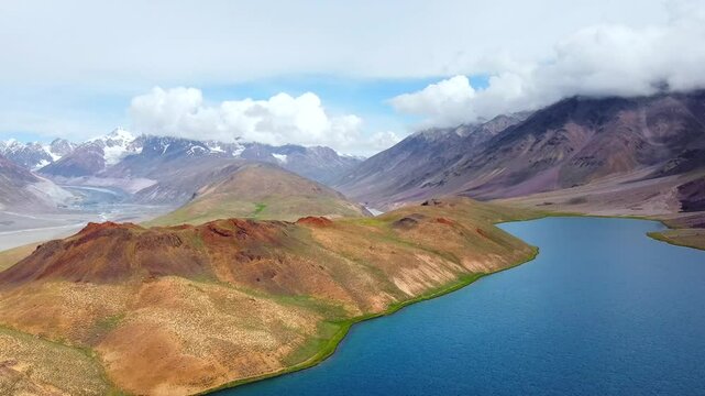 Aerial view of chandratal lake surrounded by snow-capped Himalayan mountains at chandratal in lahaul and spiti valley himachal pradesh, India.
