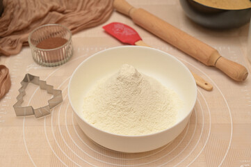 Christmas homemade baking, ingredients for baking gingerbread, sifted flour in a white bowl