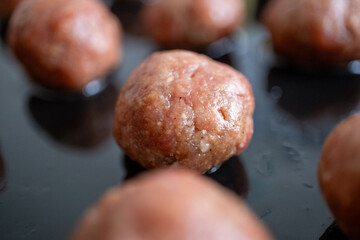 Round Swedish meatballs on a black tray