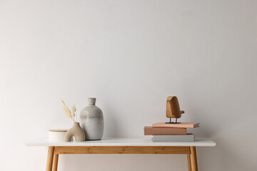 Stylish console table with decor near white wall indoors. Space for text