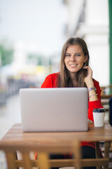 Fototapeta premium Young businesswoman on a coffee break. Using tablet computer.