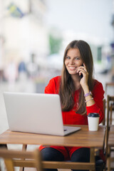 Young businesswoman on a coffee break. Using tablet computer.