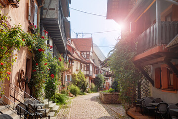 Idyllic European town lane with historic architecture and blooms