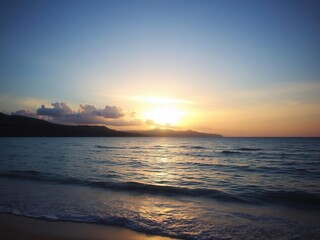 Obraz premium Beautiful sunset over a serene beach with crystal clear water and golden sand, horizon, relaxation, landscape