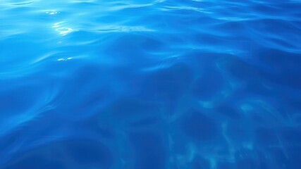 Obraz premium Rippling patterns of deep blue sea water with sunlight reflections, motion, reflection, blue