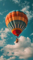 Naklejka premium A colorful hot air balloon soaring through a bright sky with fluffy clouds.