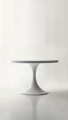 White pedestal table with tulip base, round top. Modern minimalist design. Simple clean lines. Elegant furniture piece. Ideal for home office. Contemporary style. Functional, stylish accent piece.