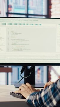 Programmer at desk typing code into computer, developing software programs, consulting green screen tablet. Man in home office fixing errors in application using chroma key device and PC, camera B