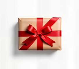 Top view of festive gift box. Gift box wrapped in light brown craft paper. Red ribbon tied in beautiful bow on top of box. Simple, elegant presentation ideal for Christmas celebration. Perfect for