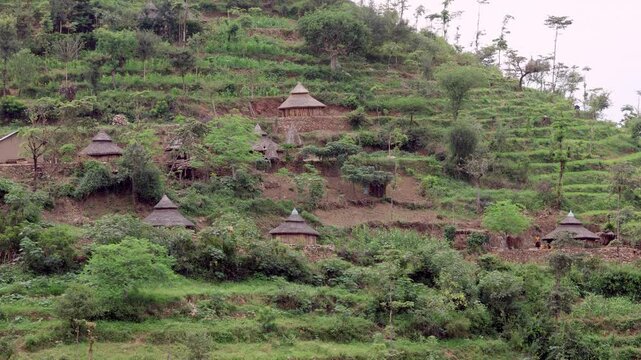 Slow motion shot of a village of quaint huts on a hillside in the Konso area of Ethiopia. Konso is a Unesco World Heritage Site known for its ancient terraced farms.