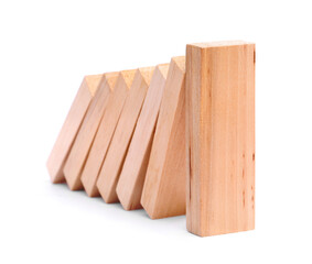 Domino effect. Wooden blocks falling on white background