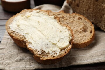 Fresh bread with butter on table, closeup