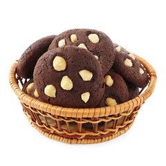 Tasty chocolate cookies with hazelnuts in wicker basket isolated on white