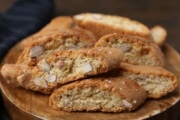 Tasty almond biscuits (Cantuccini) on wooden board, closeup