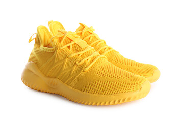 Pair of stylish yellow sneakers isolated on white