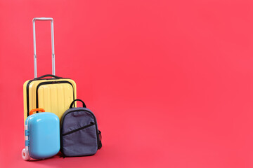 Travel abroad. Suitcases and backpack on red background. Space for text